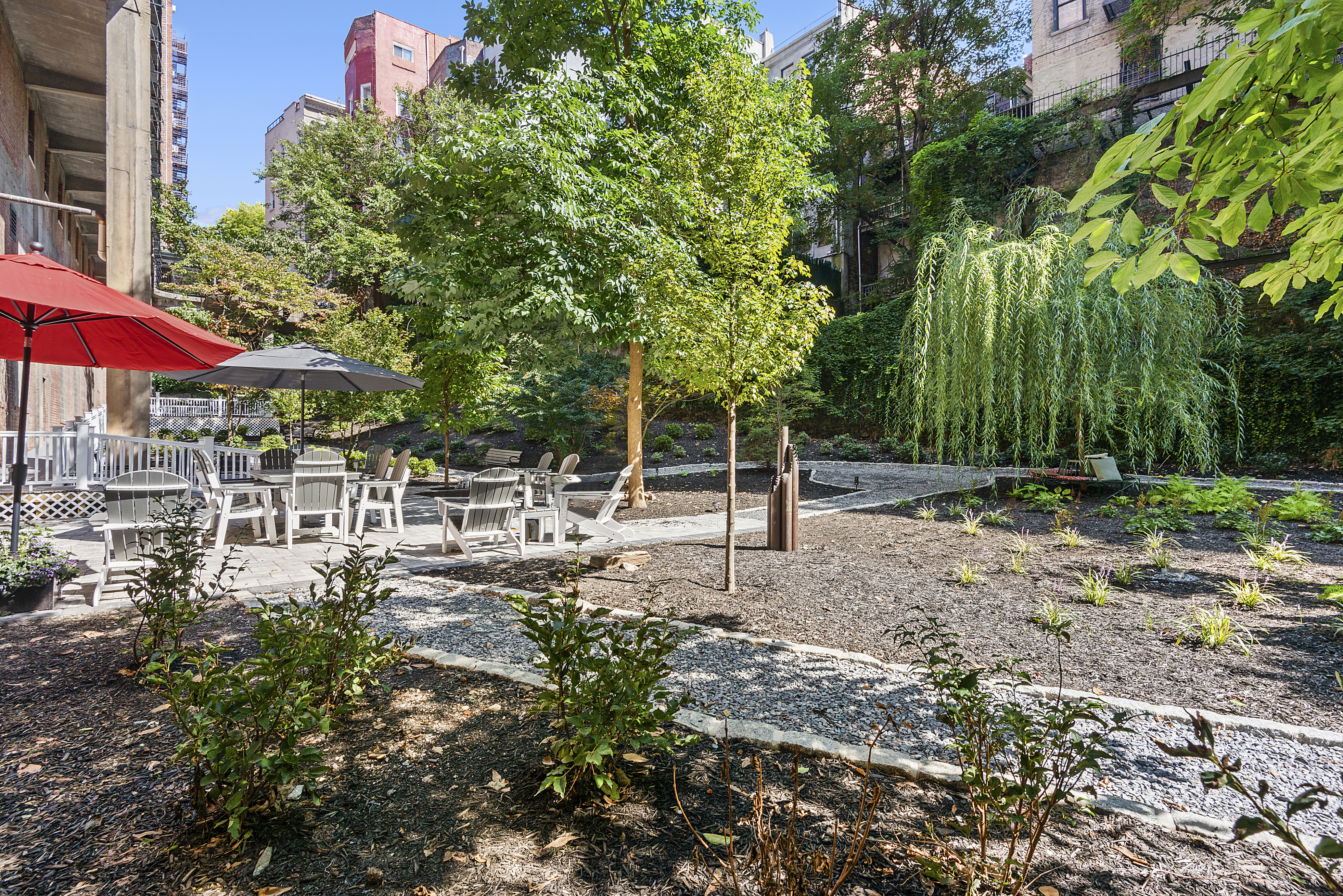 159-00 Riverside Drive West, Unit 4L70 Manhattan, NY 10032 - Photo 15 of 18 a view of a patio with table and chairs under an umbrella