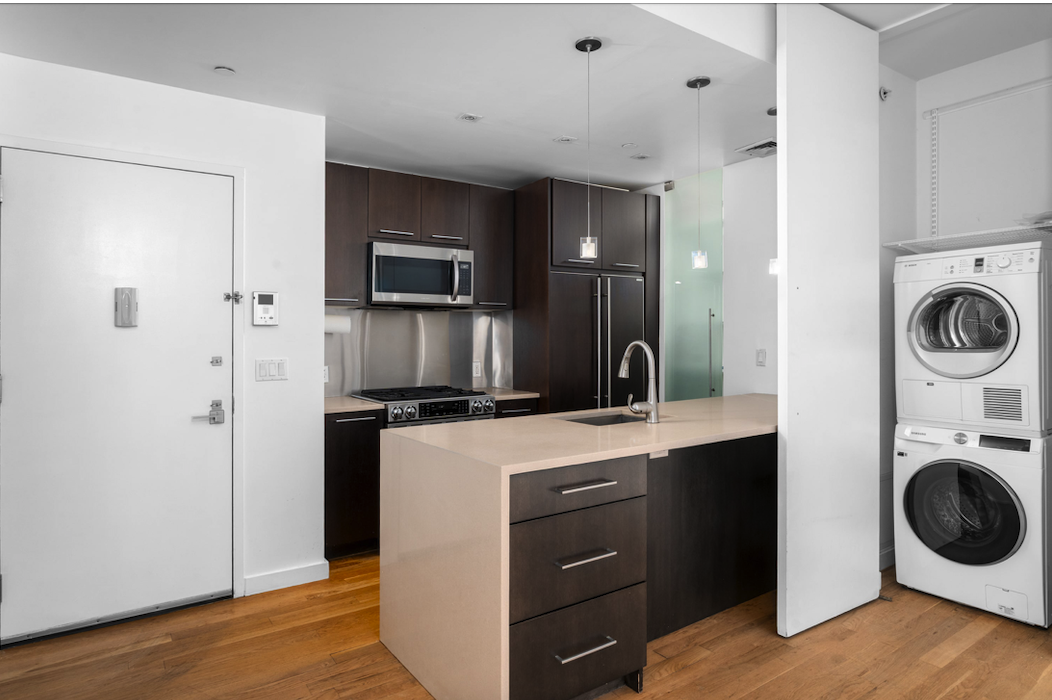 342 East 110th Street, Unit 3D Manhattan, NY 10029 - Photo 4 of 15 a kitchen with a stove top oven a sink and a refrigerator