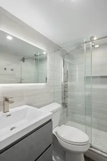 a bathroom with a sink toilet and shower