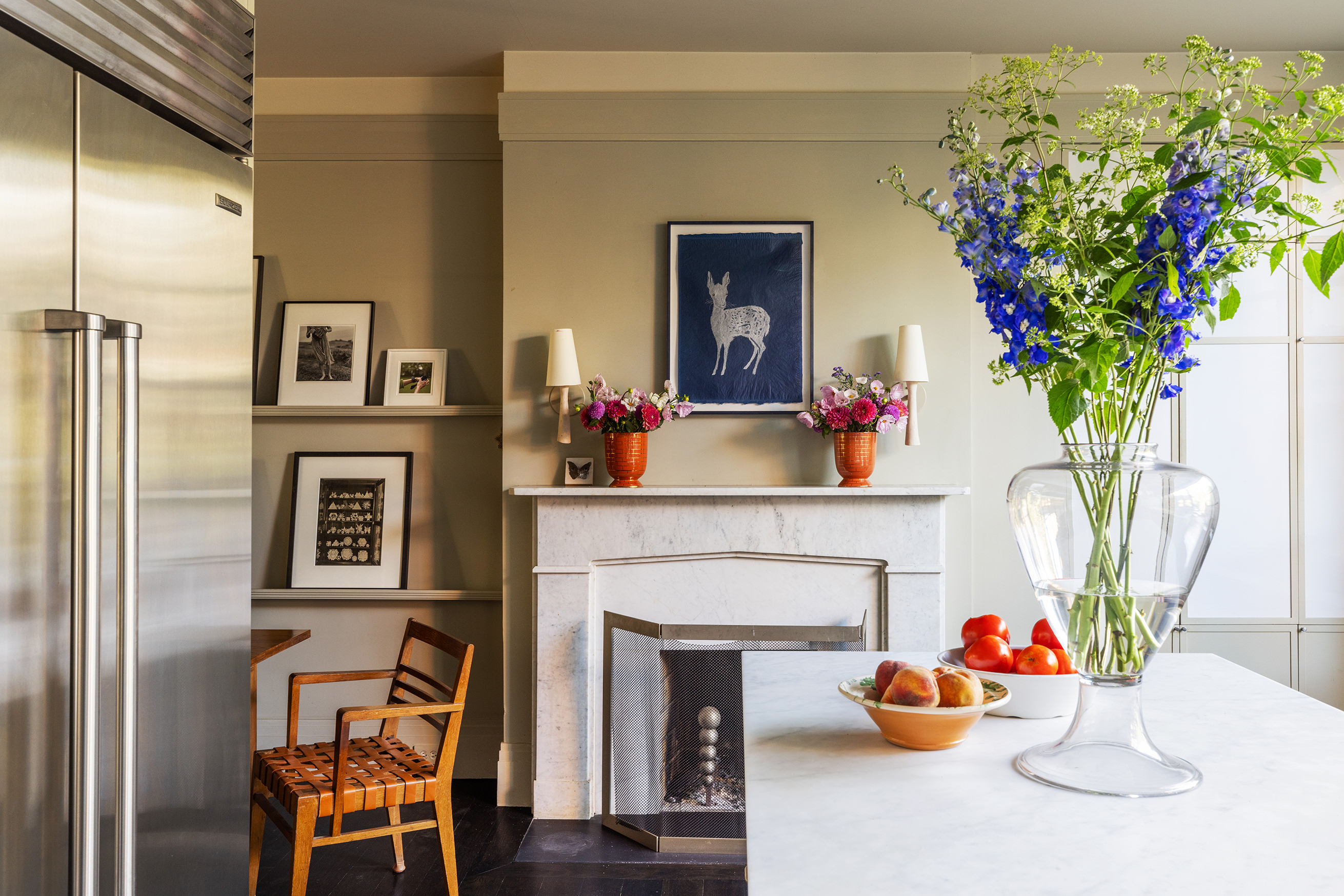 25 Perry Street Manhattan, NY 10014 - Photo 15 of 32 a vase of flowers sitting on a table with a fireplace