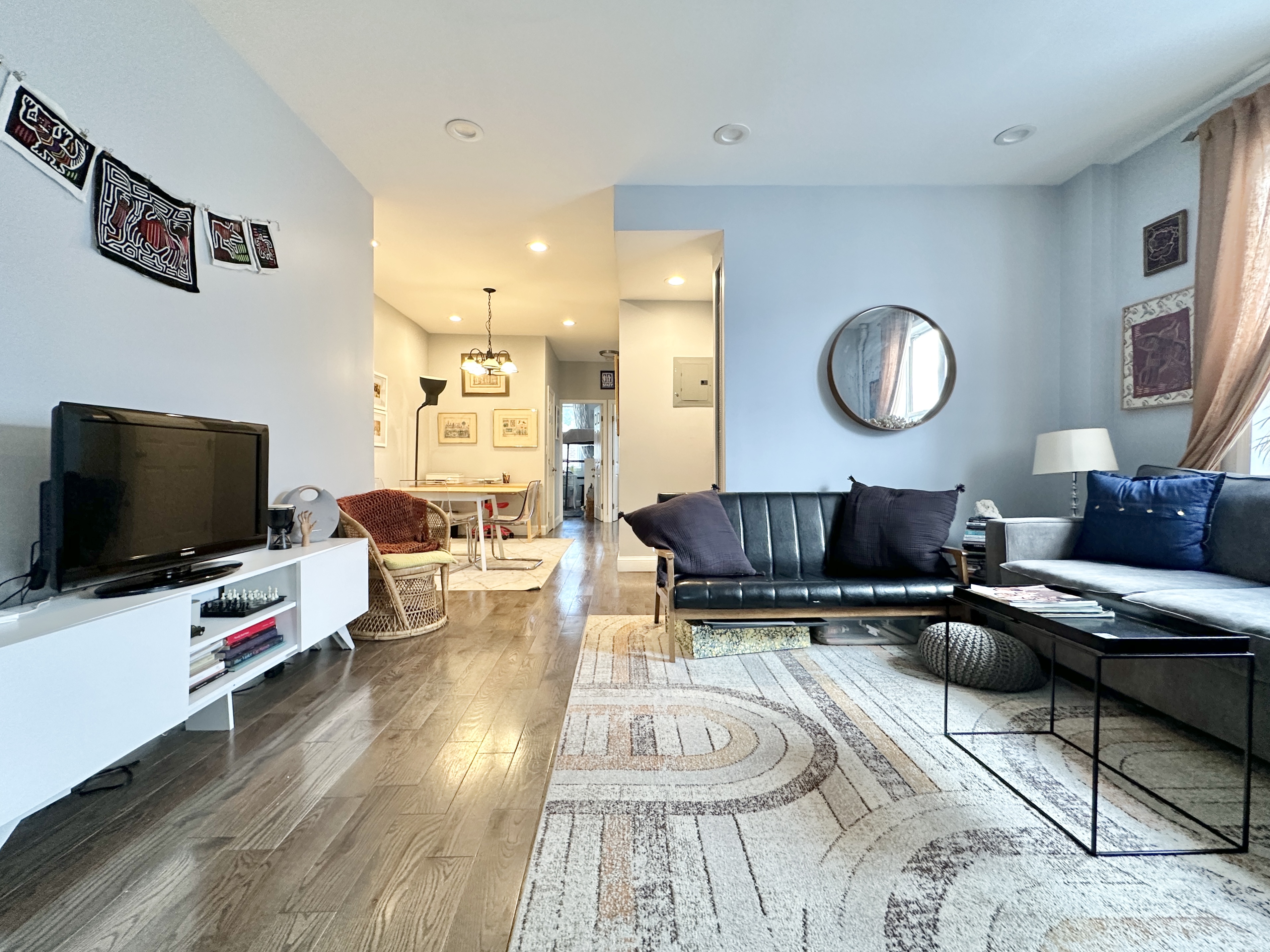 a living room with furniture and a flat screen tv