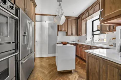 a kitchen with stainless steel appliances granite countertop a refrigerator and a sink