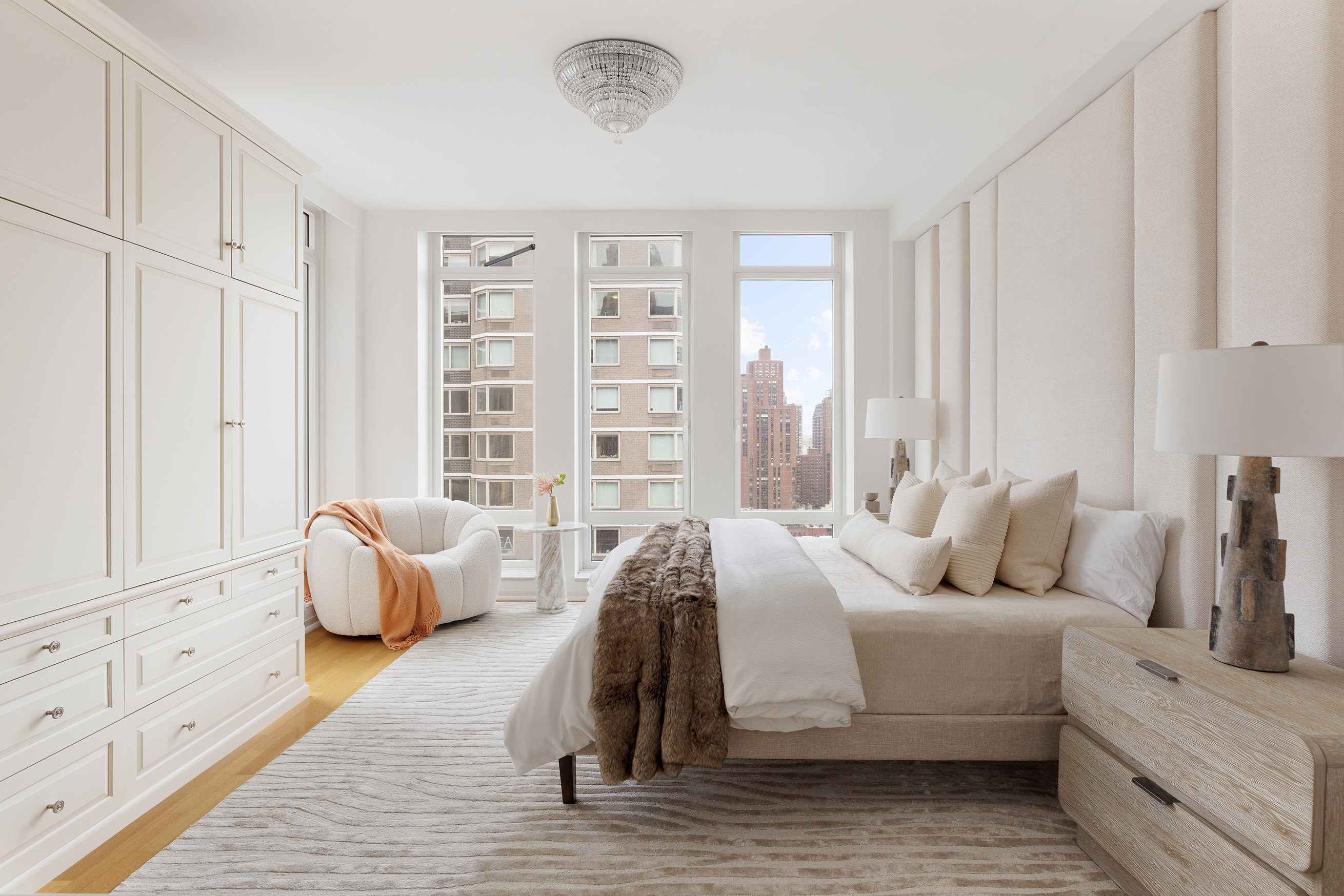 205 East 85th Street, Unit 19B Manhattan, NY 10028 - Photo 7 of 9 a bed room with furniture and a large window