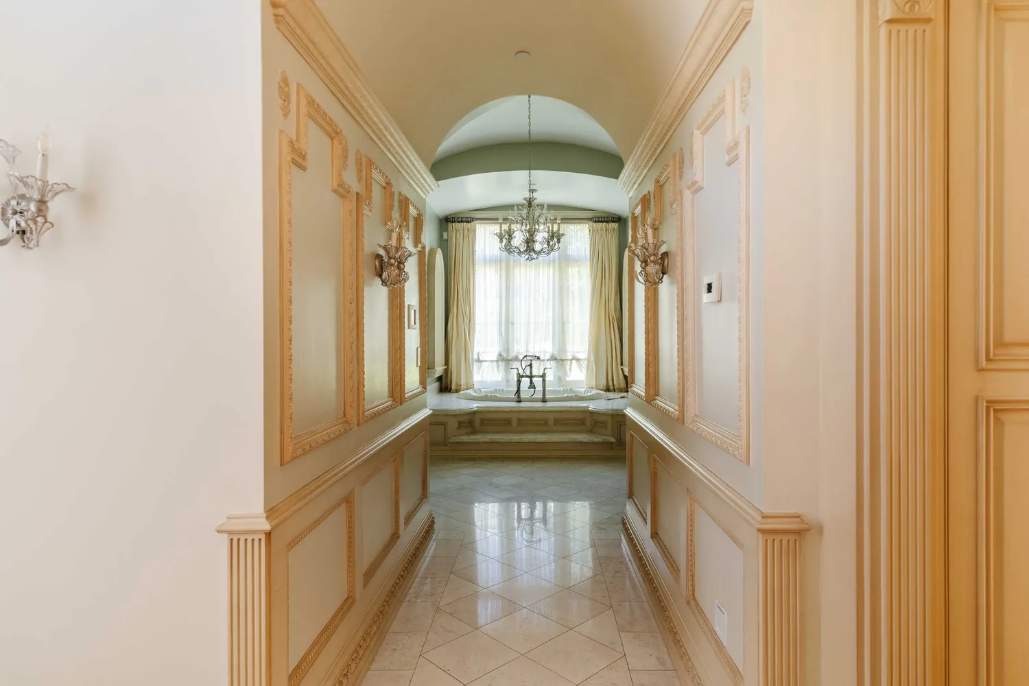 a bathroom with a tub sink and mirror