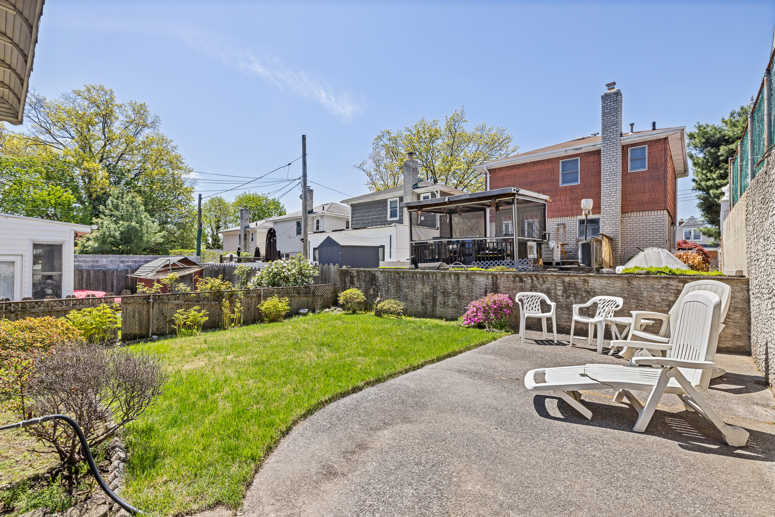 14-28 140th Street Queens, NY 11357 - Photo 13 of 14 a view of a house with backyard sitting area and swimming pool