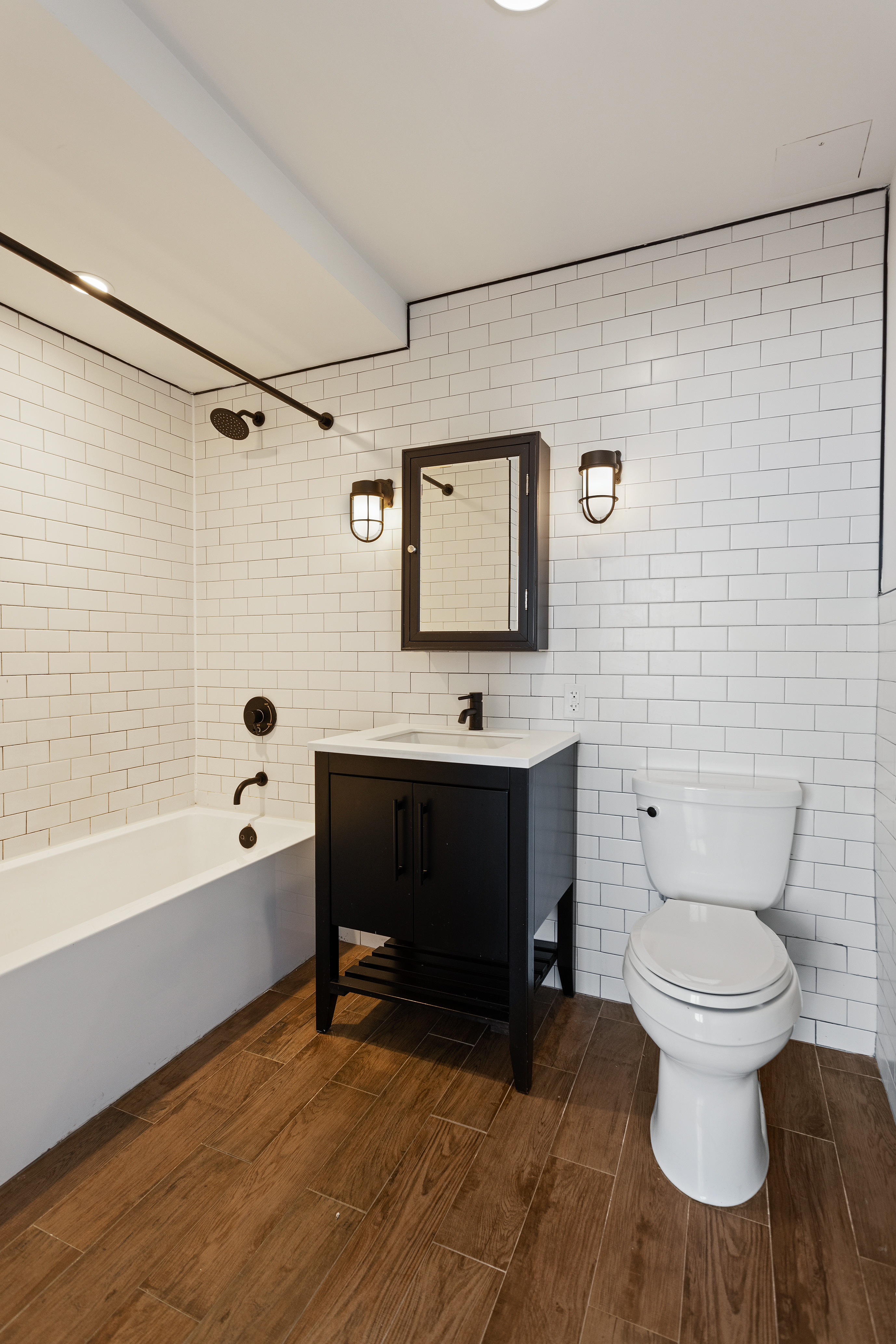 16-26 Madison Street, Unit PHA Queens, NY 11385 - Photo 6 of 16 a bathroom with a toilet a sink and bathtub