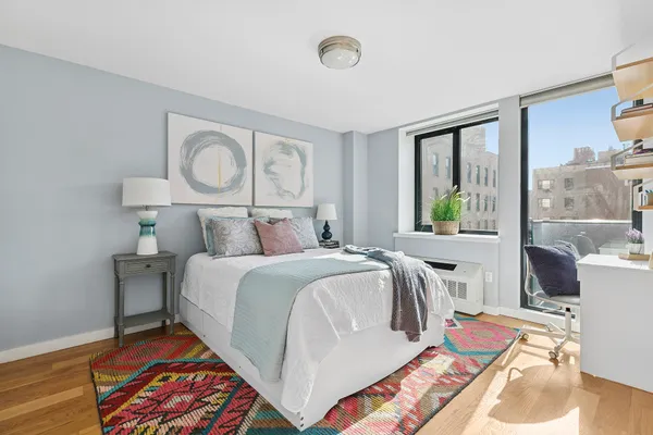 a bed sitting in a bedroom next to a window