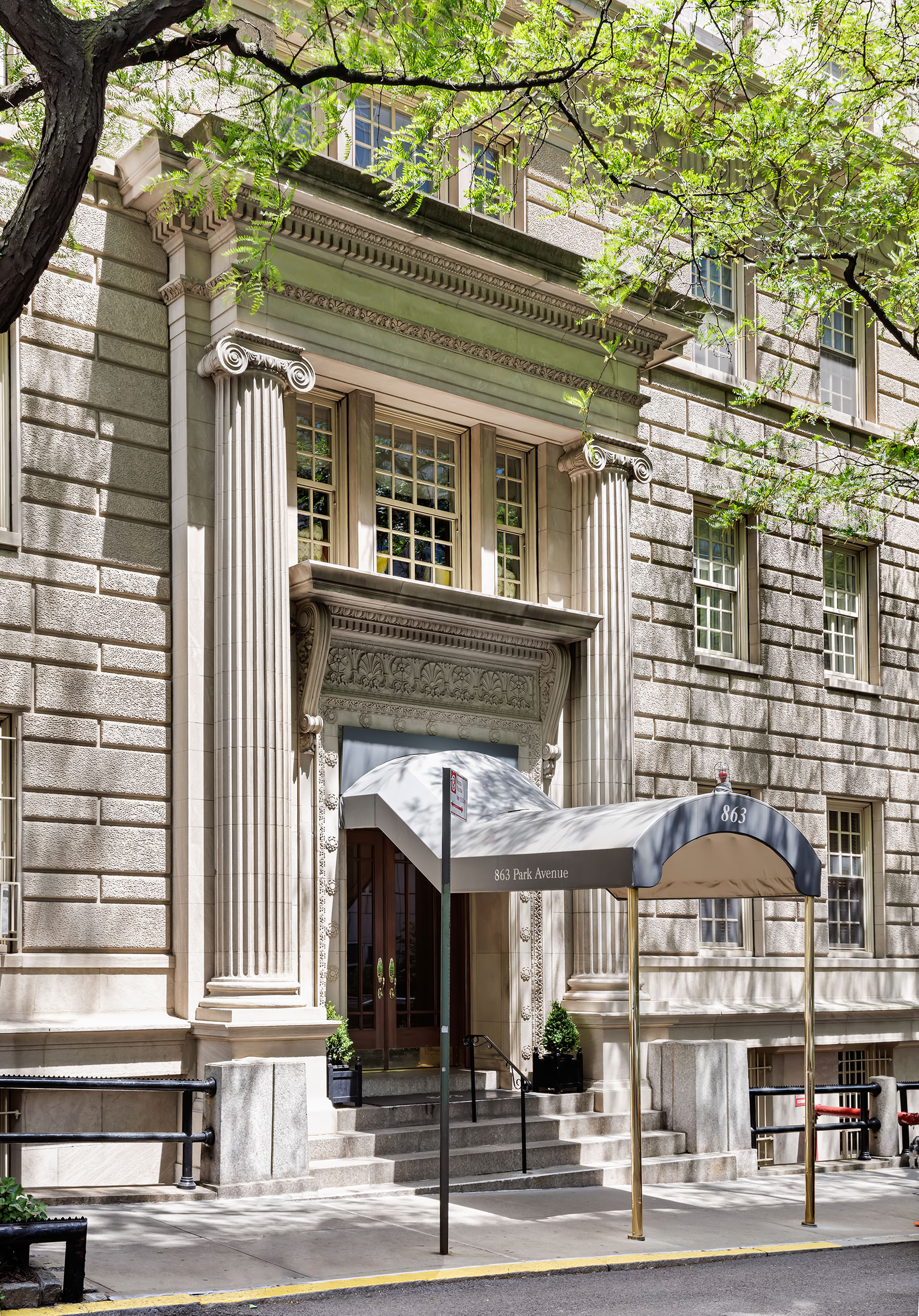 863 Park Avenue, Unit 8W Manhattan, NY 10075 - Photo 12 of 15 a front view of a building and a street