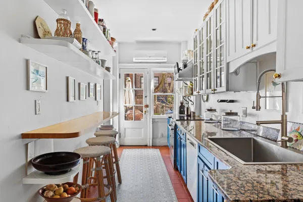 a kitchen with stainless steel appliances a sink a stove and a refrigerator