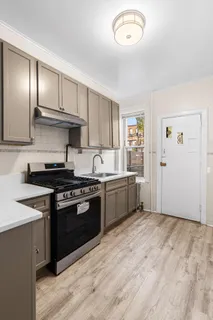 a kitchen with granite countertop stainless steel appliances and wooden cabinets