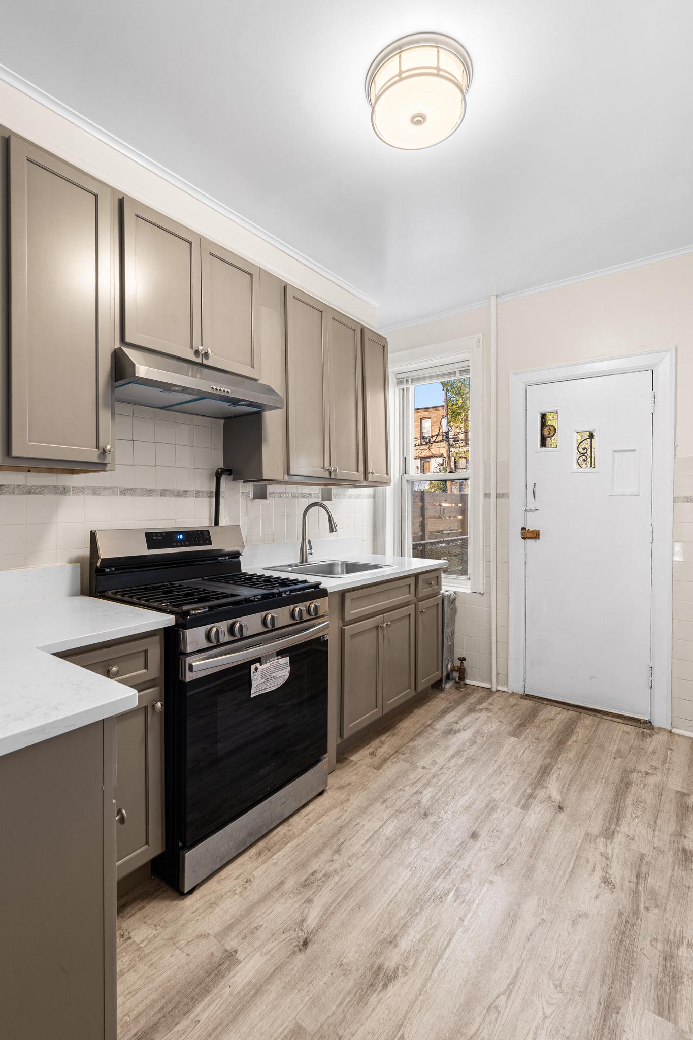 a kitchen with granite countertop stainless steel appliances and wooden cabinets