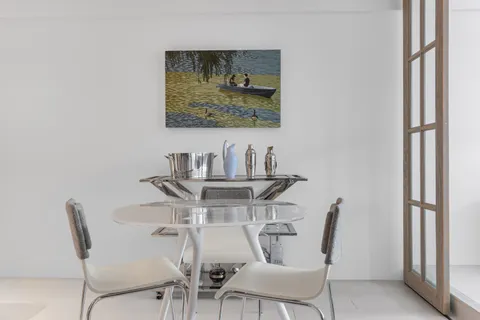 a view of a dining room with furniture and a window