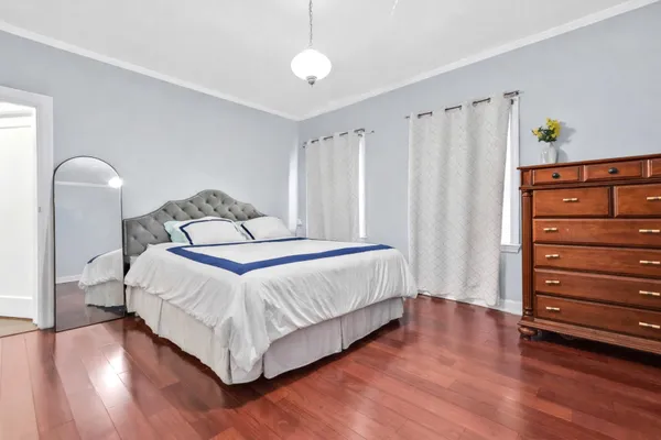 a bedroom with a bed and a dresser