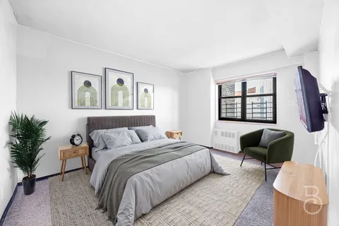 a bedroom with a bed and a couch