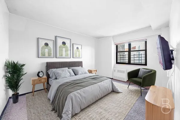 a bedroom with a bed and a couch