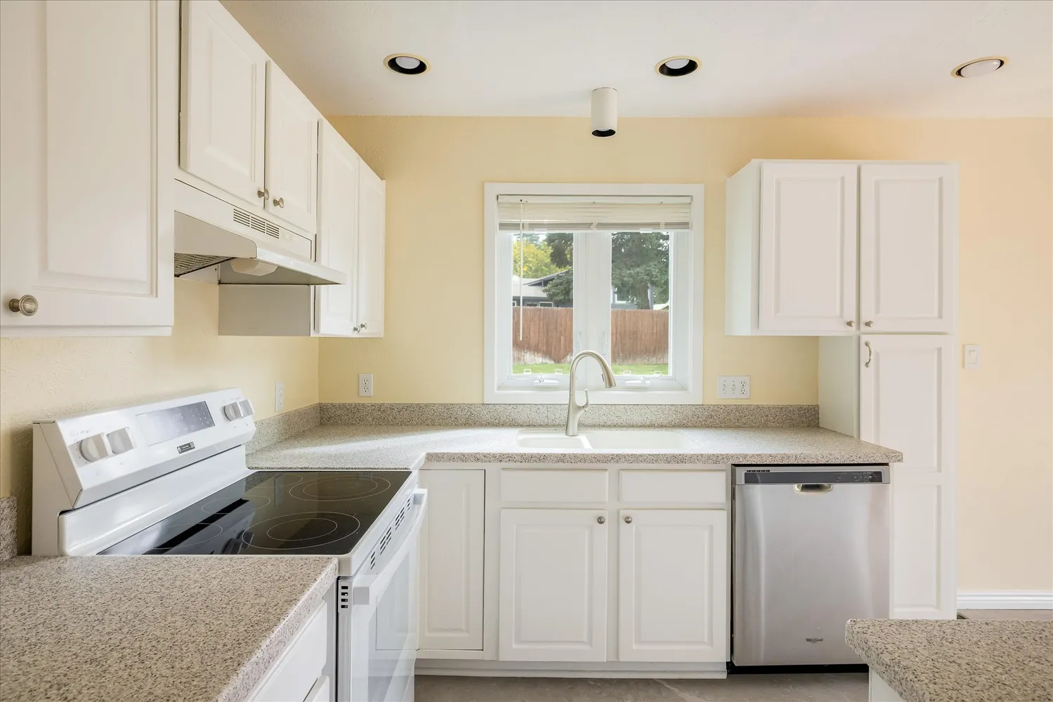 a kitchen that has a sink a stove and a window