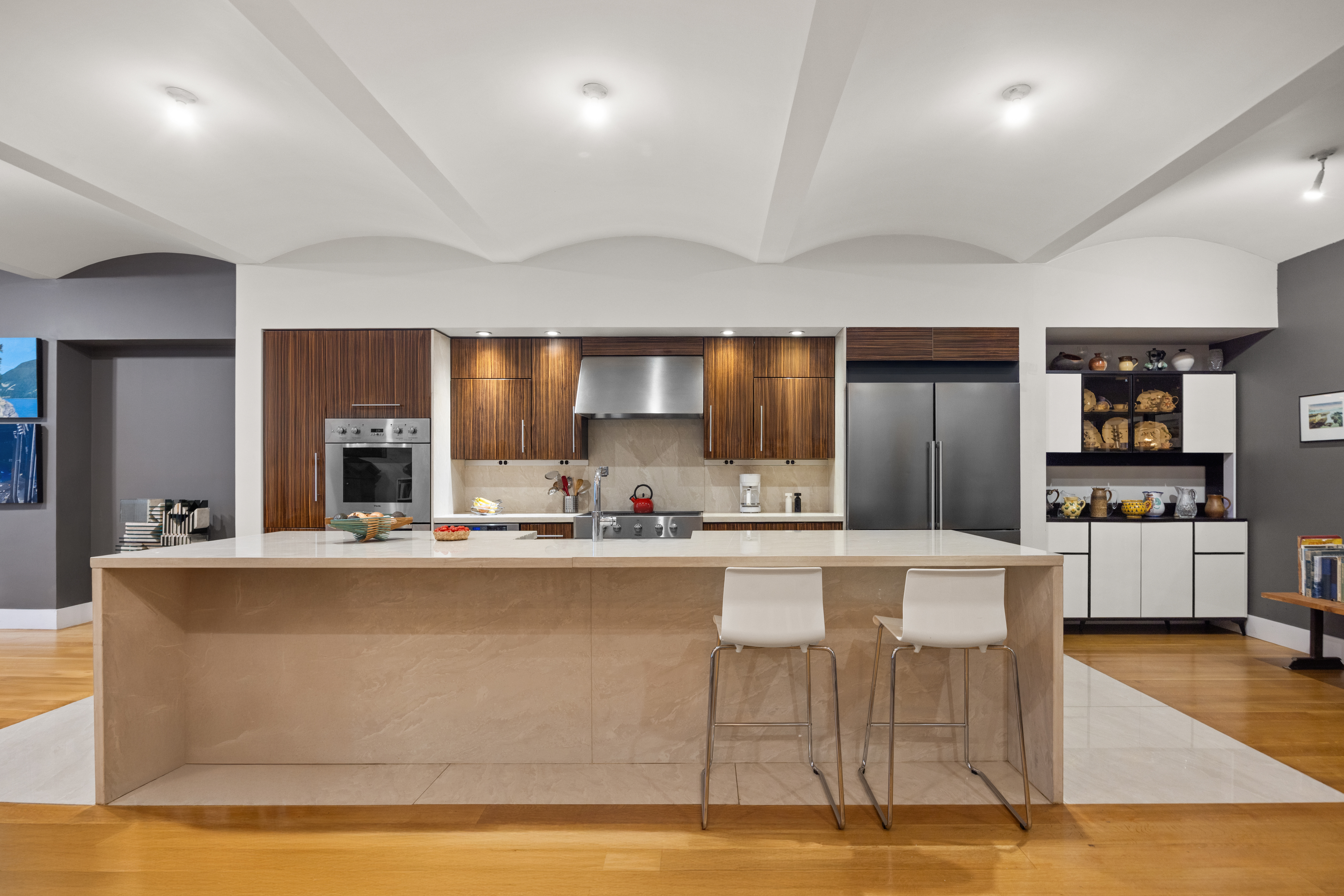 42 Ann Street, Unit 5 Manhattan, NY 10038 - Photo 5 of 16 a view of a kitchen with kitchen island a counter top space a sink a refrigerator and chairs