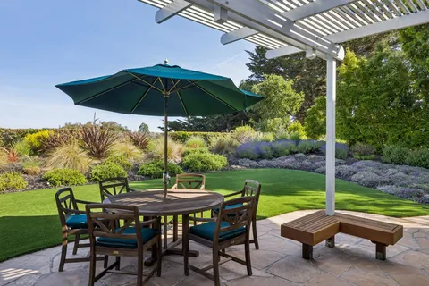 a view of a table and chairs under an umbrella