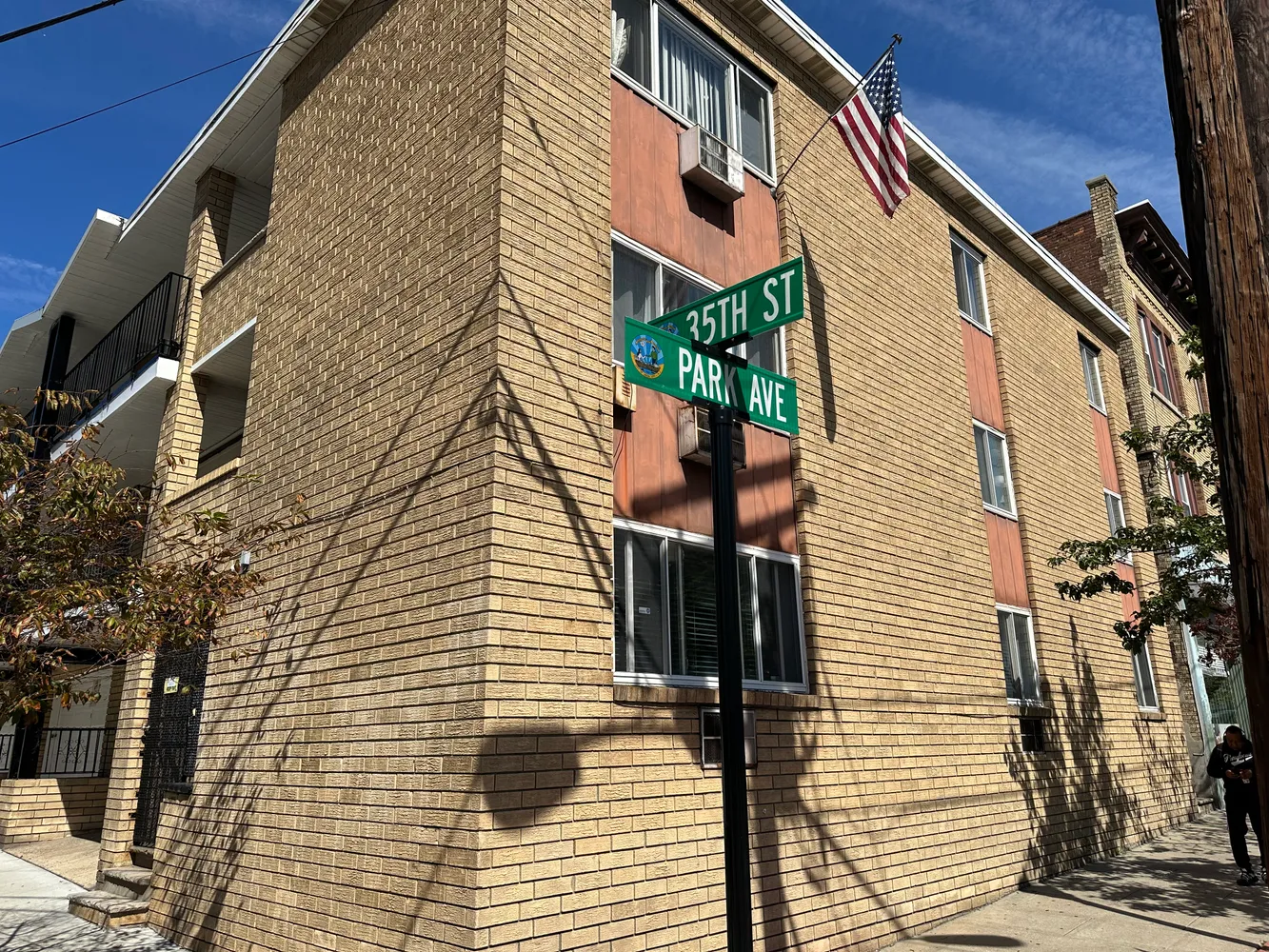 a brick building with a street sign on a wall