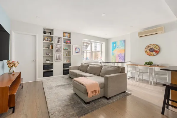 a living room with furniture and a book shelf