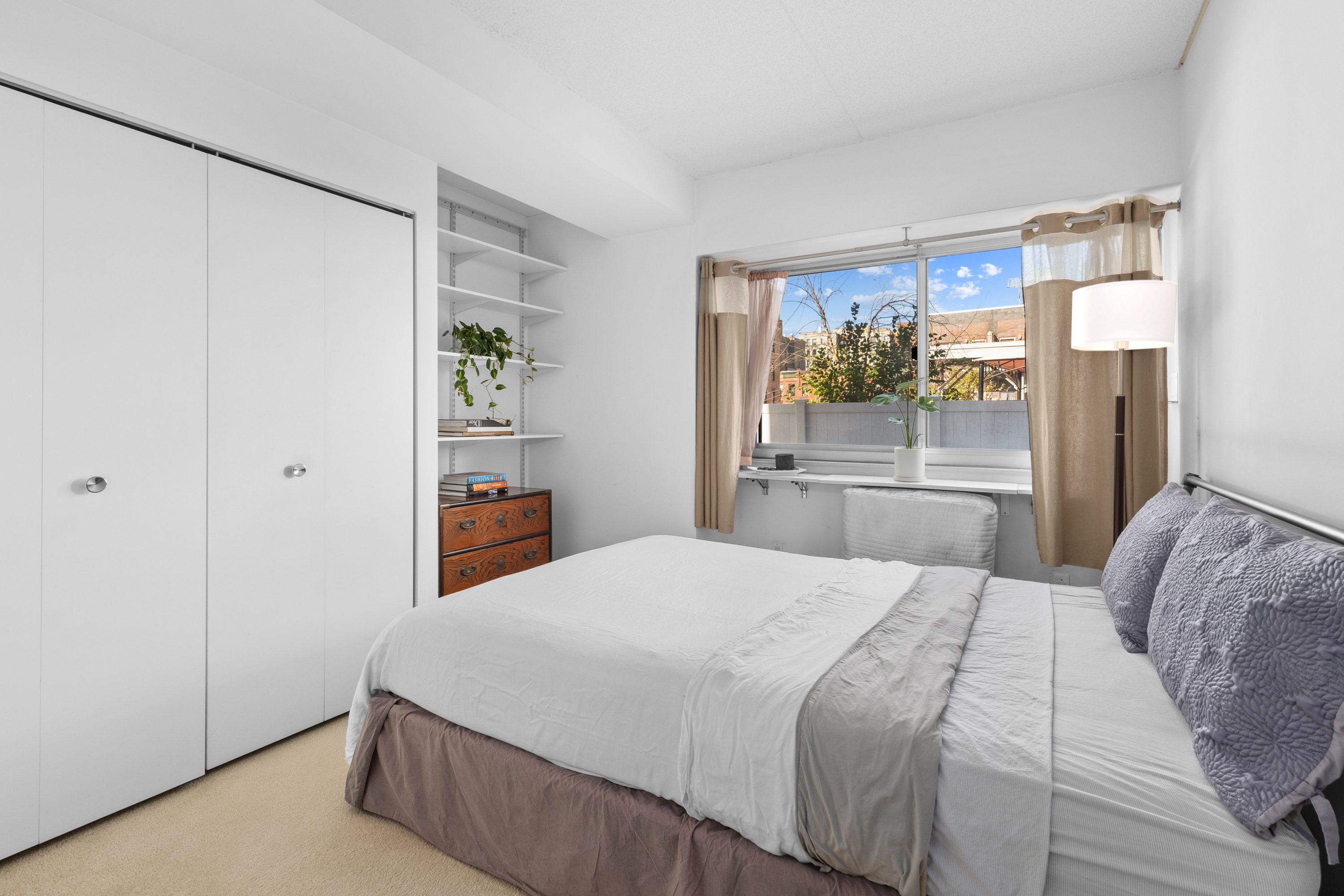 300 West 145th Street, Unit 1QQ Manhattan, NY 10039 - Photo 10 of 15 a bedroom with a bed and a window