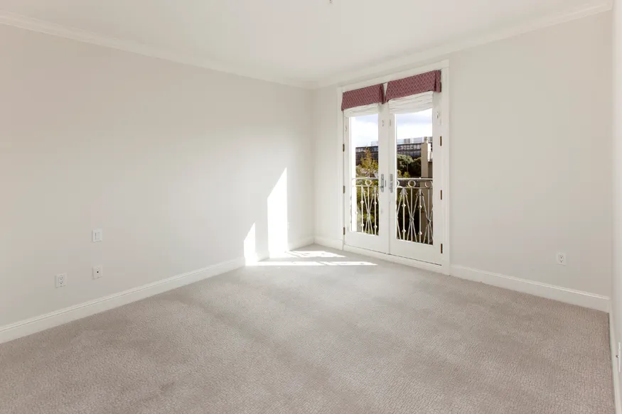 an empty room with windows and entrance