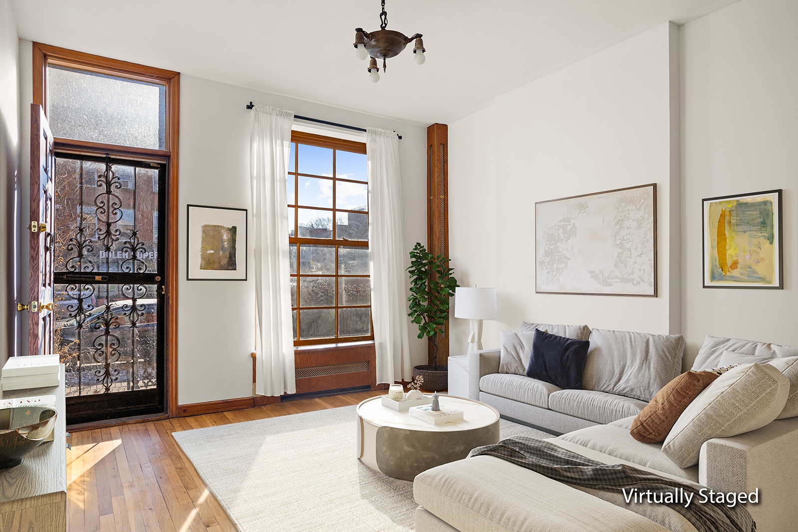 1682 8th Avenue Brooklyn, NY 11215 - Photo 2 of 16 a living room with furniture and a potted plant