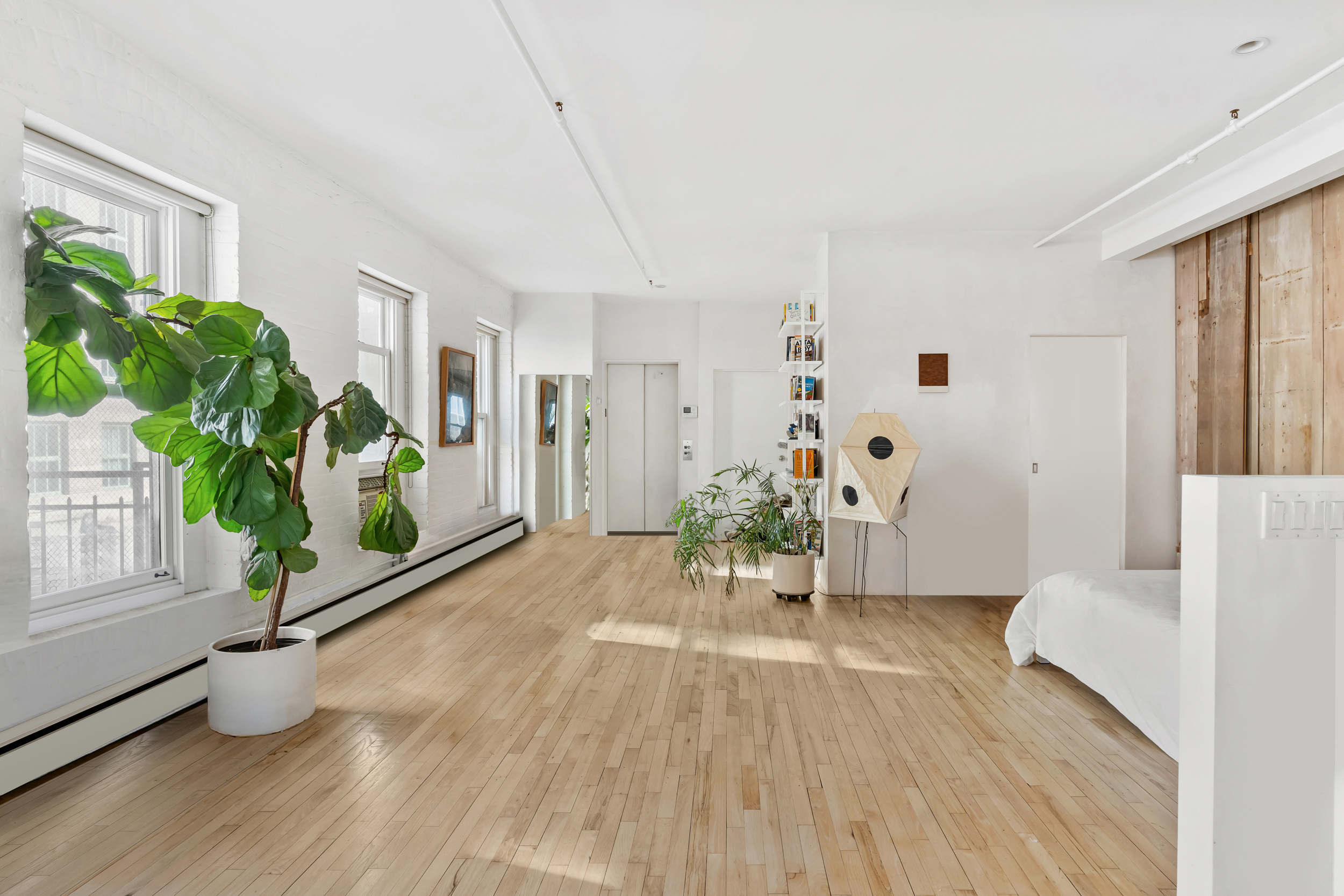 19 Hubert Street, Unit 3 Manhattan, NY 10013 - Photo 3 of 8 a living room with furniture and a potted plant