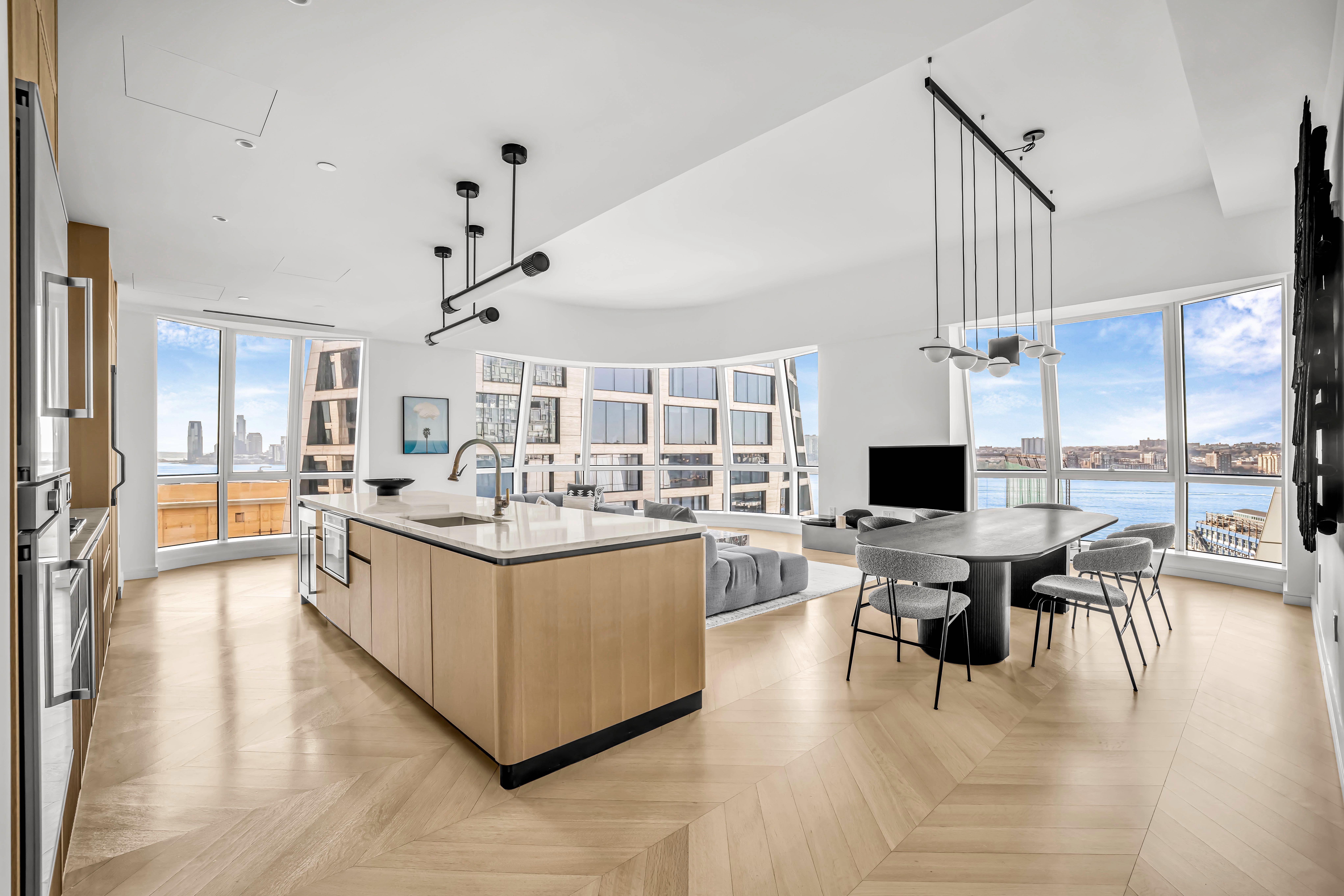 515 West 18th Street, Unit 1504 Manhattan, NY 10011 - Photo 2 of 11 a living room with stainless steel appliances kitchen island granite countertop a sink and a refrigerator