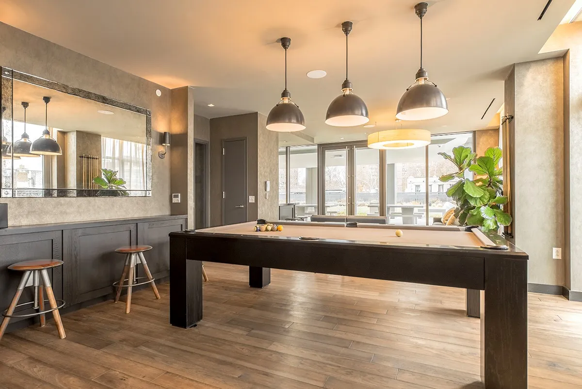 a dining room with a wooden table and chairs