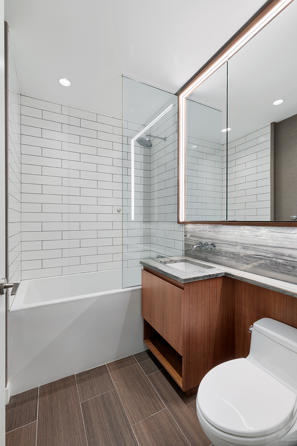 15 William Street, Unit 22H Manhattan, NY 10005 - Photo 11 of 20 a bathroom with a sink a toilet and bathtub