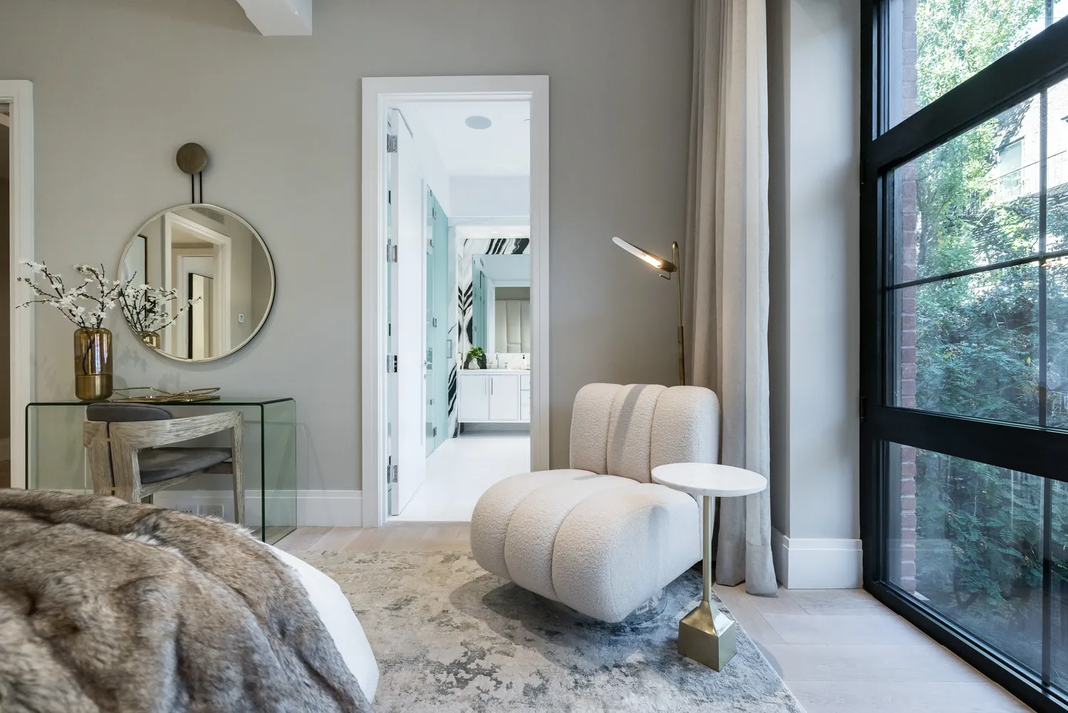 a bedroom with a bed a mirror and a fireplace