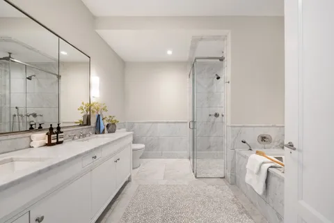a bathroom with a double vanity sink mirror double and shower