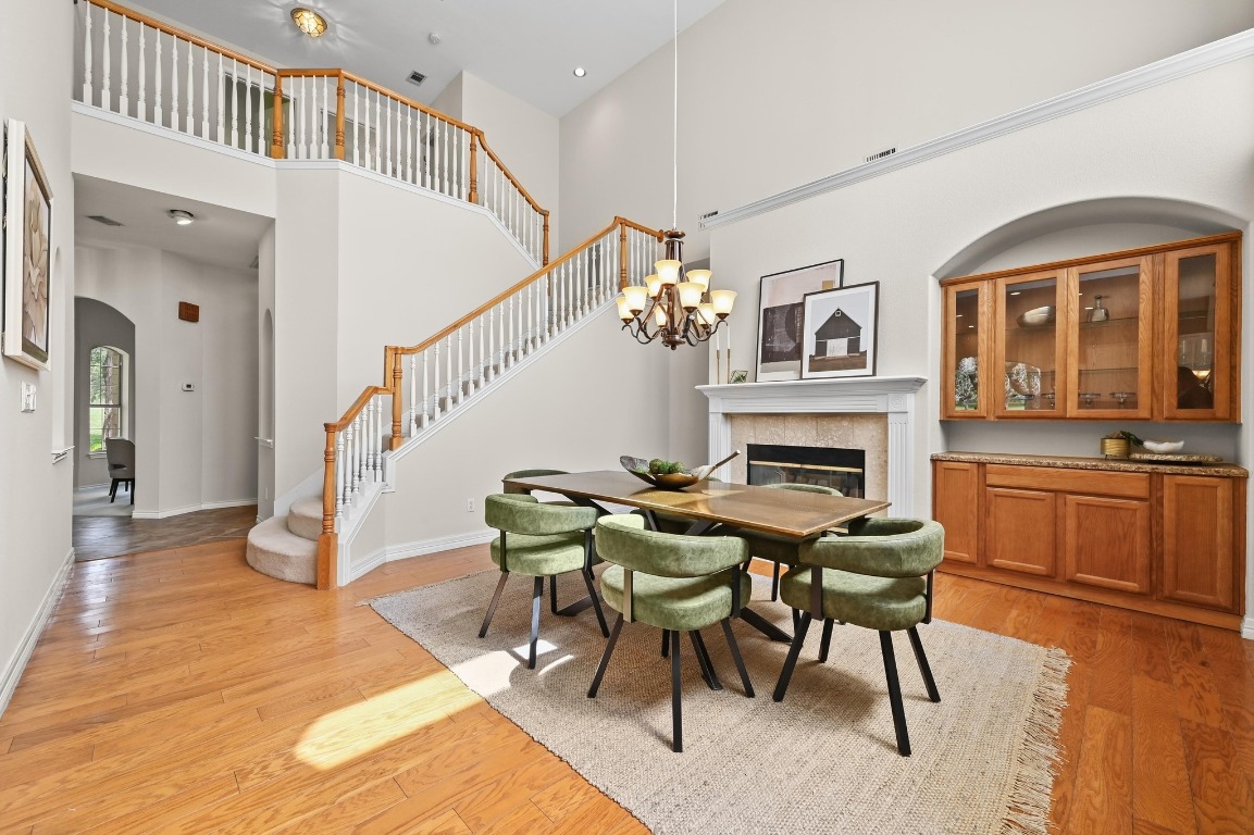111 Trinity Street Cedar Creek, TX 78612 - Photo 11 of 38 a dining room with furniture a rug a fireplace and a chandelier