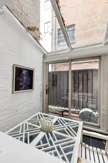 a view of a patio with a table and chairs