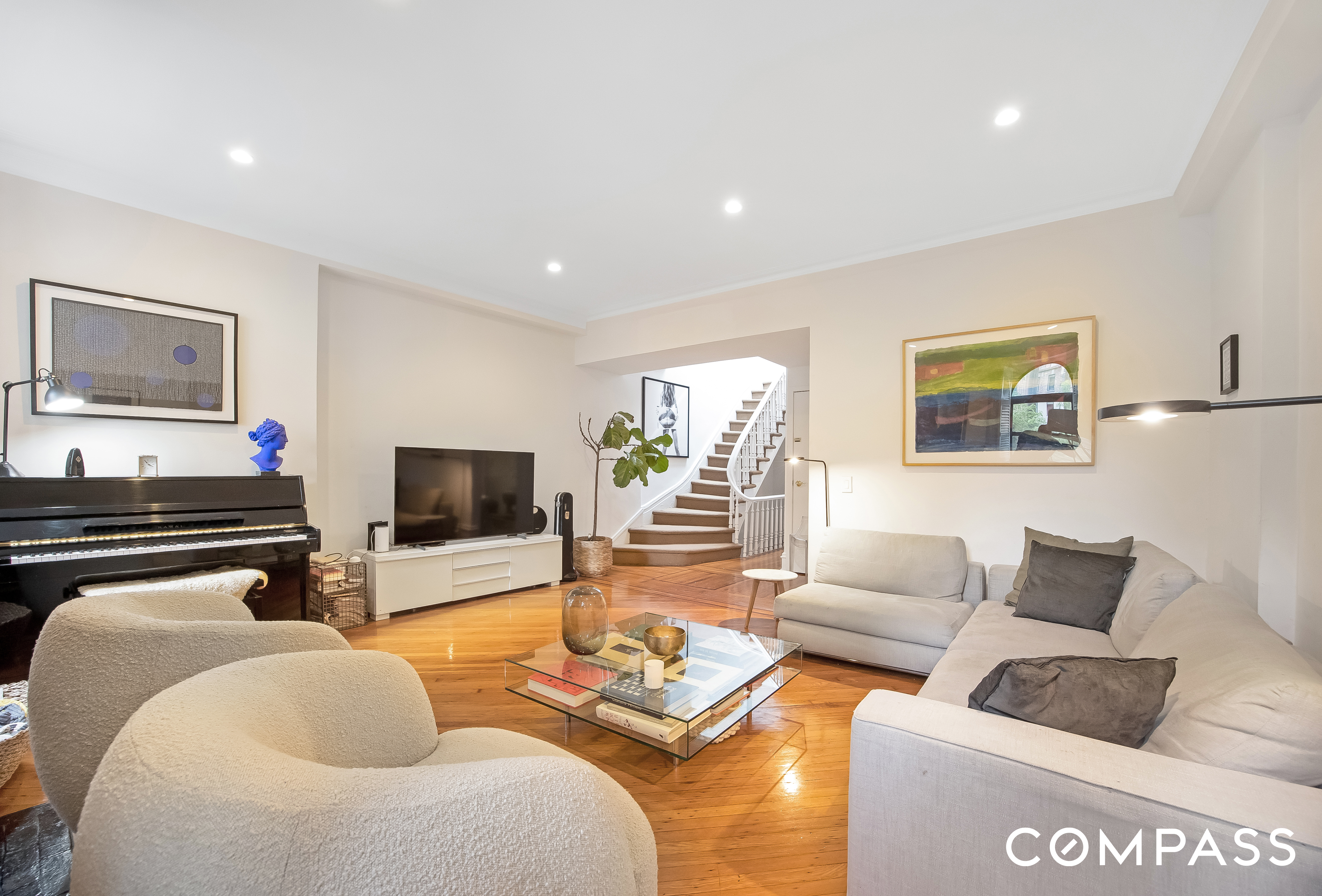 152 East 74th Street, Unit 2 Manhattan, NY 10021 - Photo 4 of 16 a living room with furniture and a flat screen tv