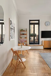 a living room with a large window and a flat screen tv