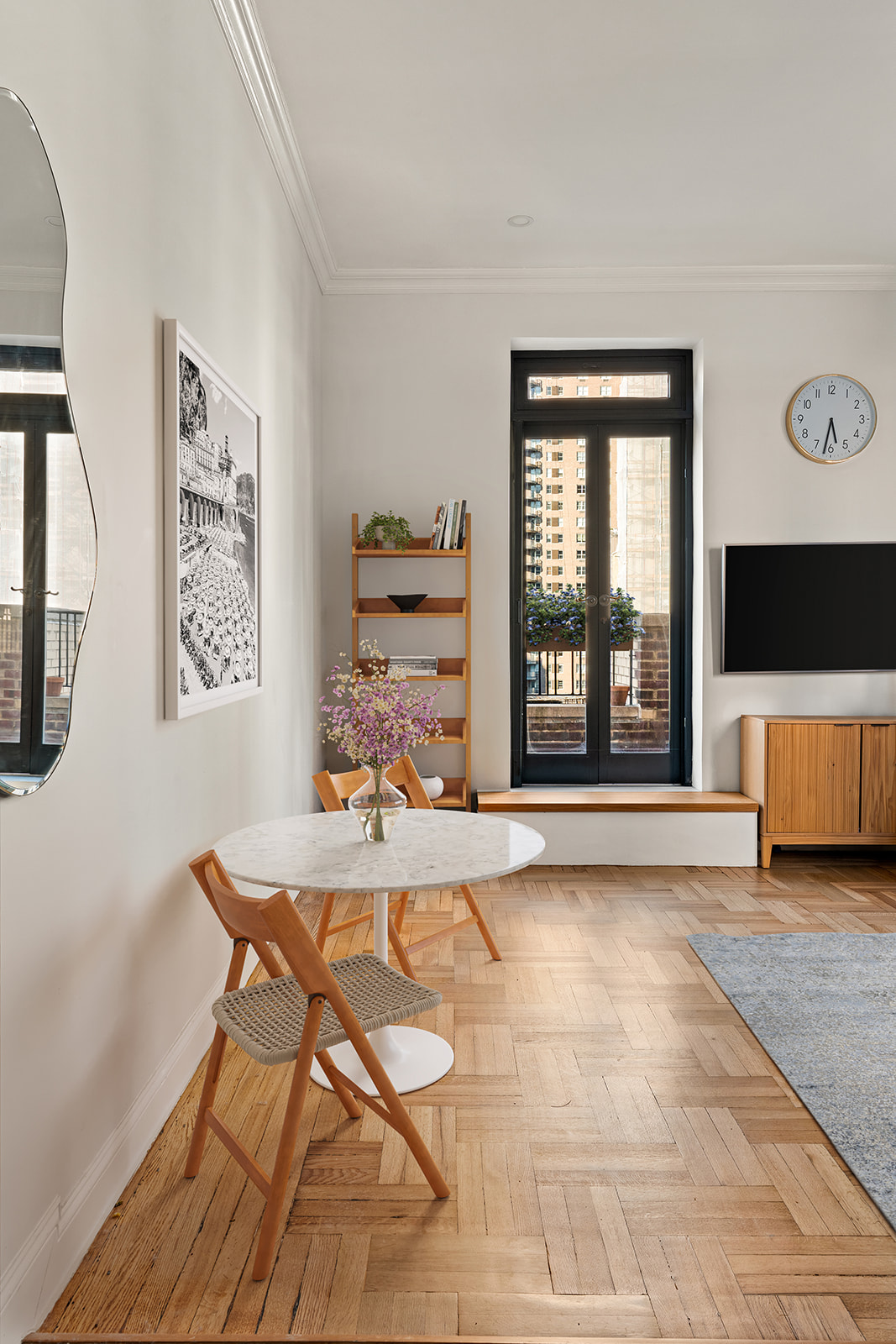 151 East 83rd Street, Unit PHC Manhattan, NY 10028 - Photo 5 of 16 a living room with a large window and a flat screen tv