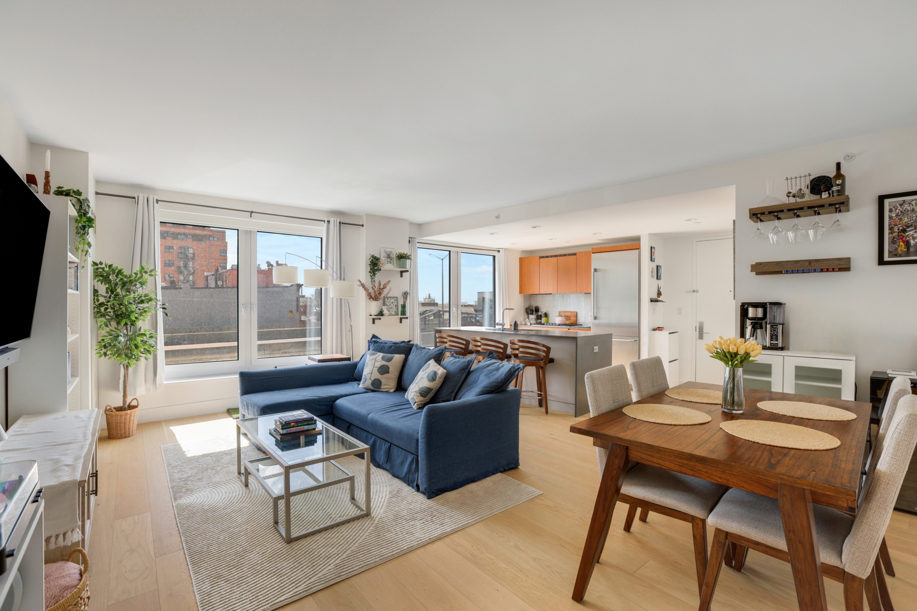a living room with furniture a large window and a flat screen tv