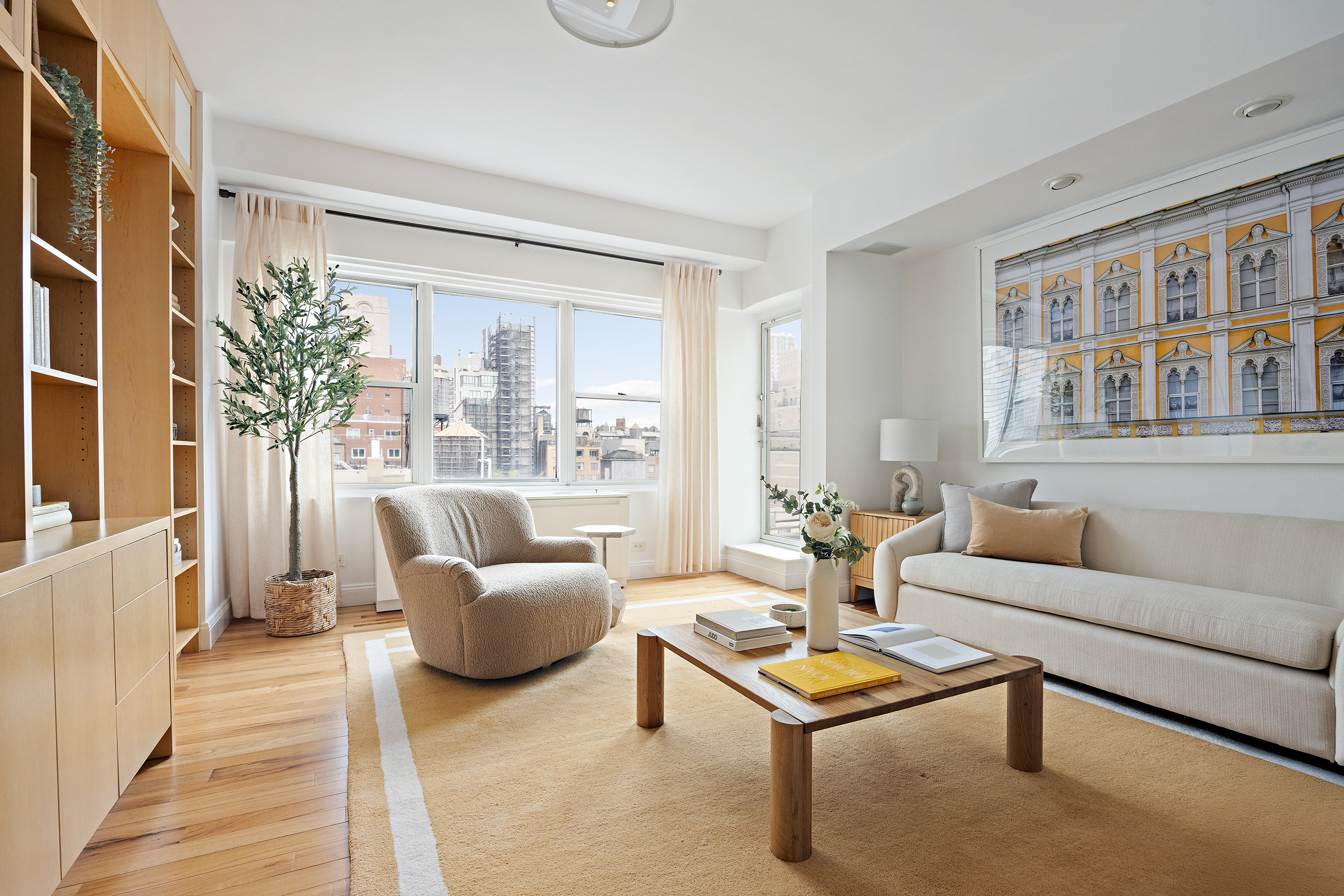 40 East 84th Street, Unit 17A Manhattan, NY 10028 - Photo 11 of 16 a living room with furniture and a potted plant