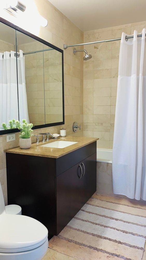 40 West 116th Street, Unit B503 Manhattan, NY 10026 - Photo 11 of 36 a bathroom with a sink and a mirror