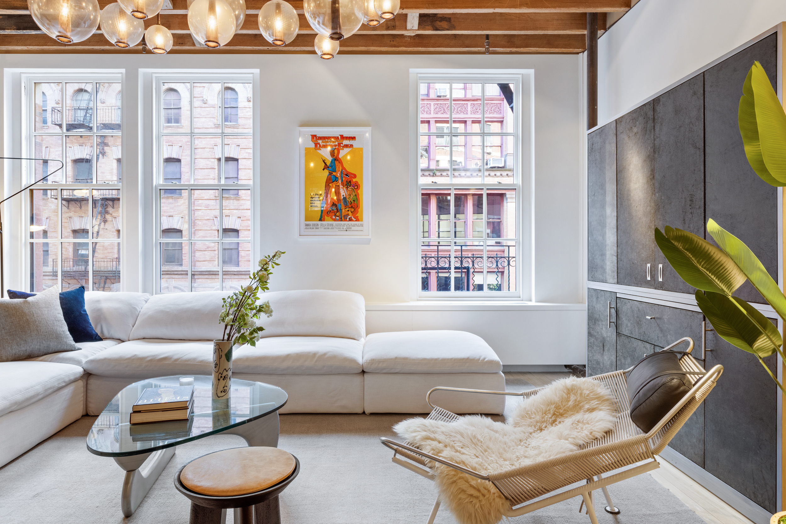 144 Franklin Street, Unit 3 Manhattan, NY 10013 - Photo 4 of 23 a living room with furniture and a window