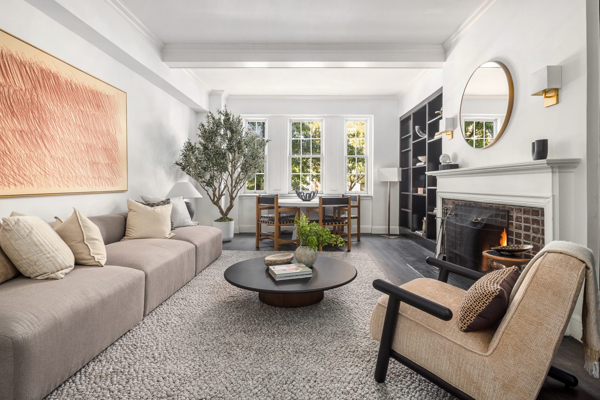 39 5th Avenue, Unit 2B Manhattan, NY 10003 - Photo 3 of 12 a living room with furniture a fireplace and a large window