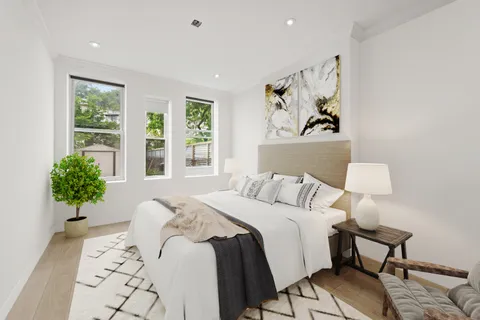 a bedroom with a bed and a painting on the wall