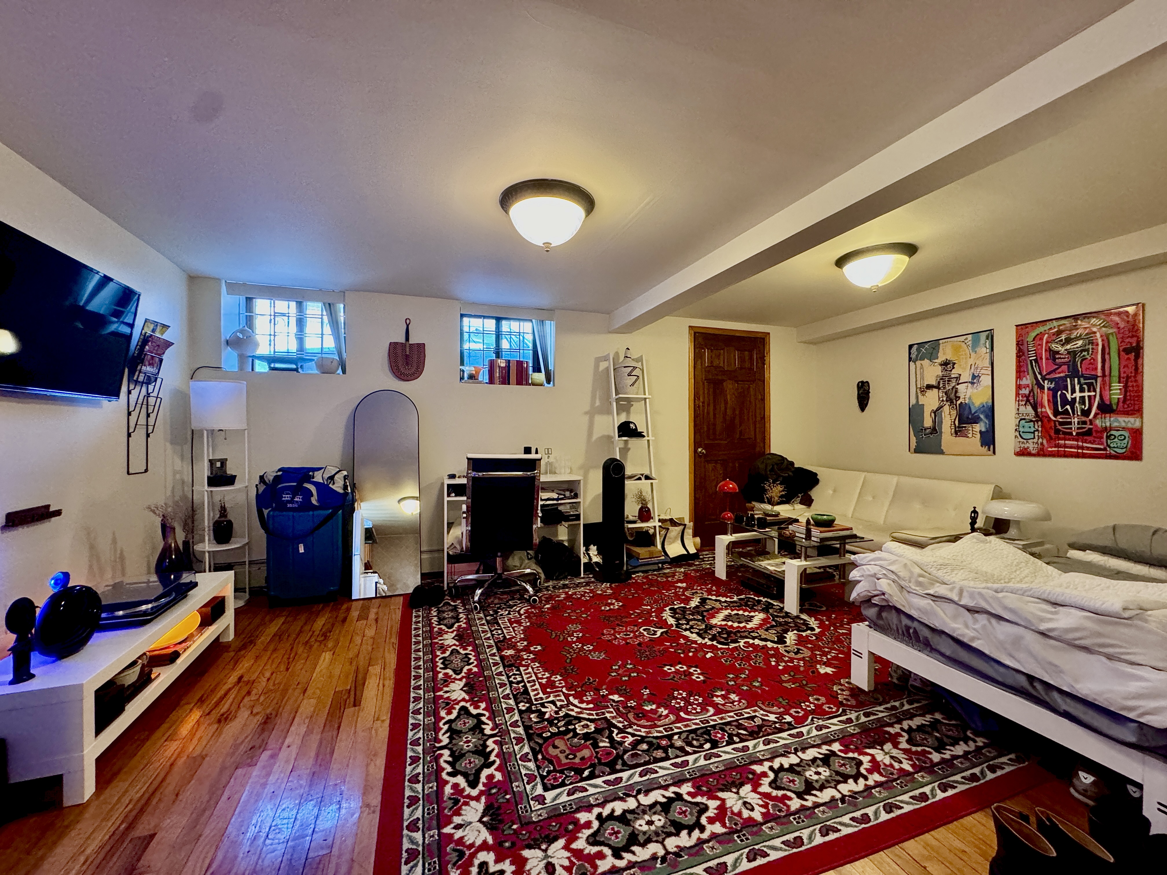 1561 Carroll Street, Unit Undisclosed Brooklyn, NY 11213 - Photo 2 of 9 a living room with furniture and a flat screen tv
