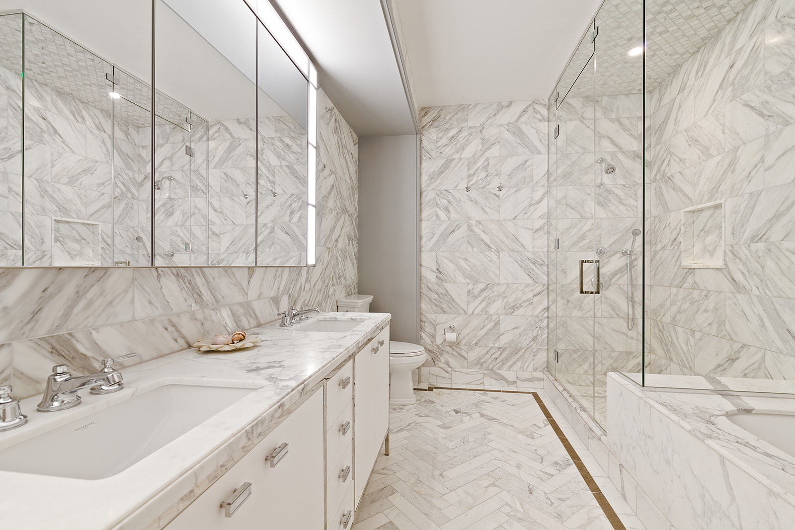 100 Barclay Street, Unit 13K Manhattan, NY 10007 - Photo 8 of 11 a bathroom with a sink and a mirror