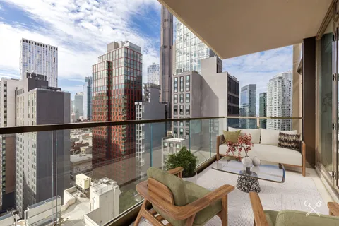 a balcony with table and chairs