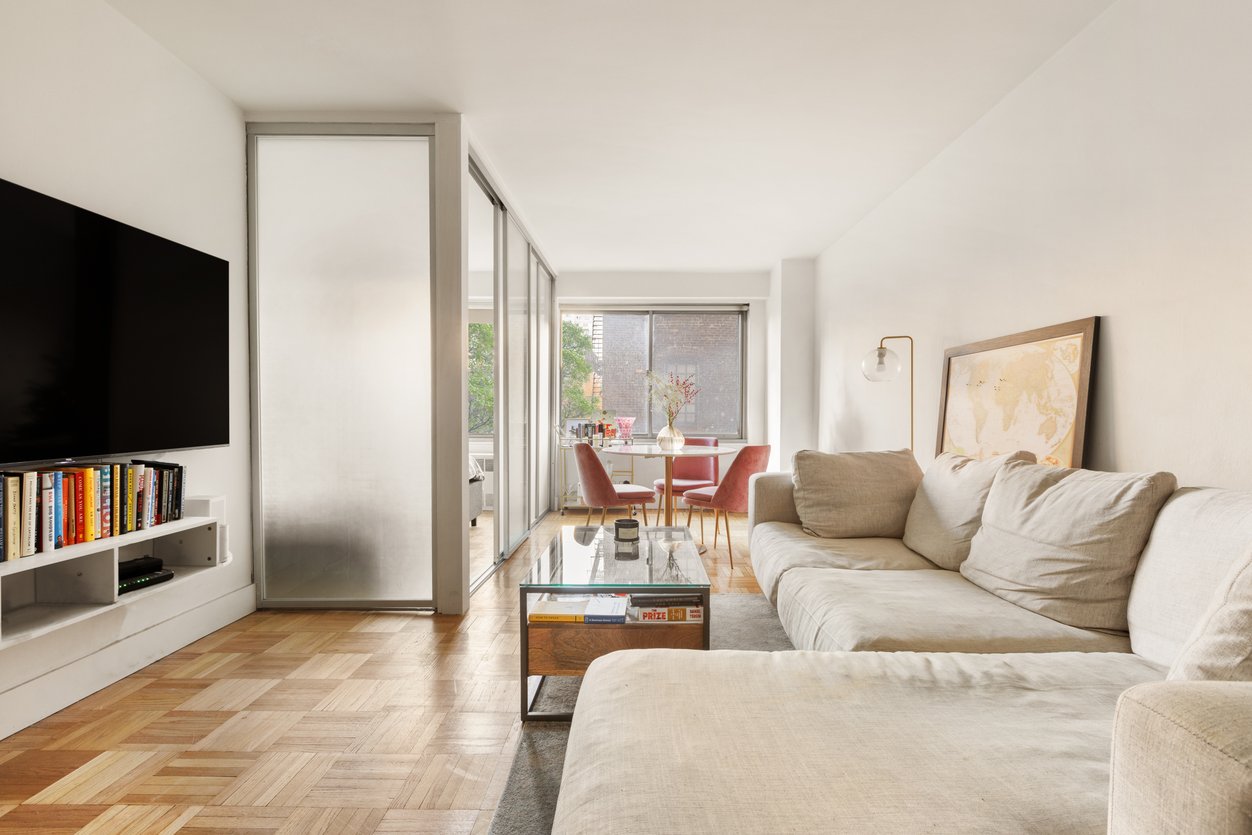 175 West 12th Street, Unit 5M Manhattan, NY 10011 - Photo 2 of 10 a living room with furniture and a flat screen tv