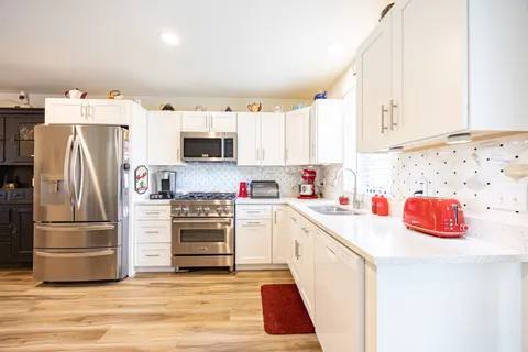 a kitchen with a refrigerator and a sink