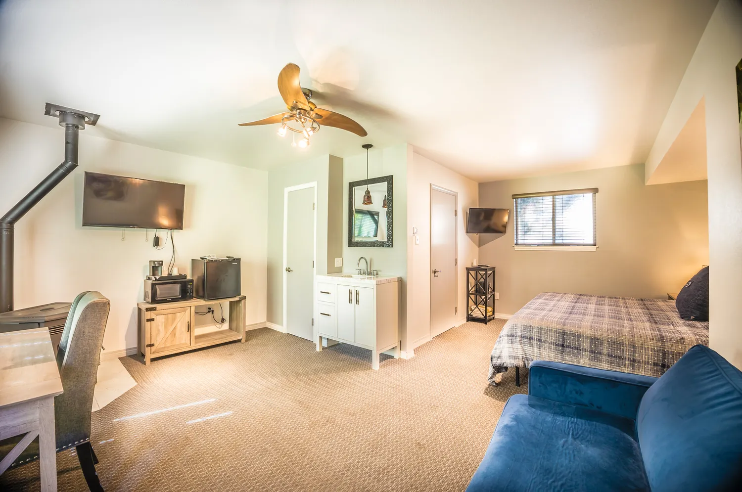 a view of a street with potted plants and large trees